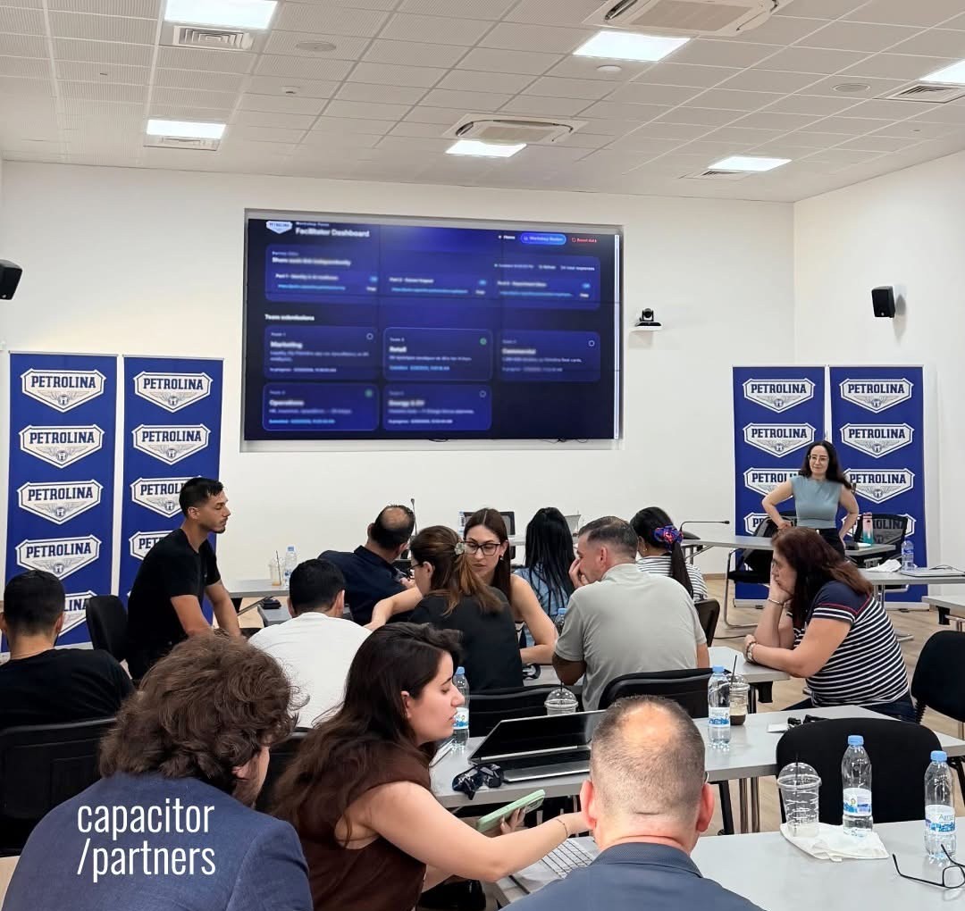Petrolina teams working through a live AI decision simulation during the Capacitor Partners workshop